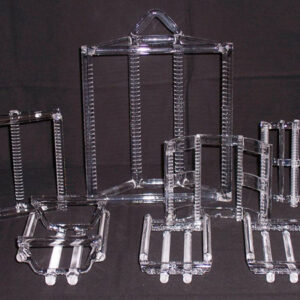 A group of clear plastic stands with white rods.