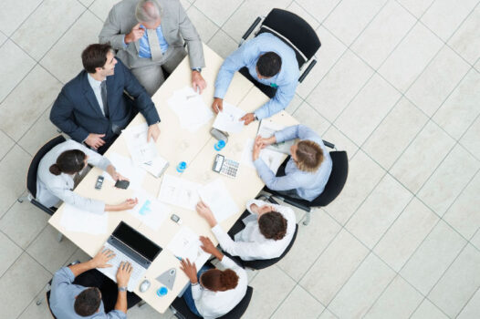 A group of people sitting around a table.