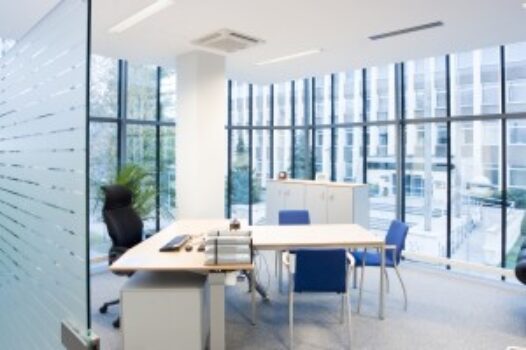 A room with many windows and tables in it