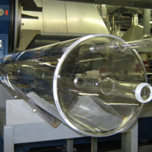 A large clear plastic tube sitting on top of a machine.